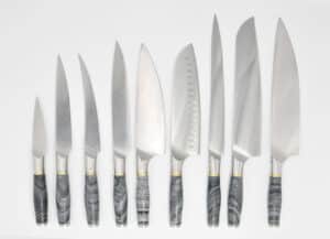9-Knife-set-with-a-Ancient-Wood-Vein-Marble-Handle-a-Champagne-Cubic-Zirconia-Stone-at-the-Back-of-the-Knife-and-Brass-and-Stainless-Steel-Decorative-Rings
