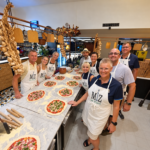 Pizza-making group in Miz en Place aprons